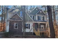 Inviting two-story home featuring stone accents, neutral siding and a welcoming porch at 488 Morris Rd, Hiram, GA 30141