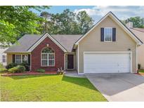 Charming single-Gathering home with a well-manicured lawn, brick facade, and an attached two-car garage at 4920 Markim Forest Ln, Sugar Hill, GA 30518