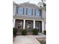 Charming two-story home with a brick facade and a welcoming front porch with large supporting columns at 1900 Old Dogwood, Jonesboro, GA 30238
