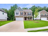 Inviting two-story home with a well-manicured lawn and a two-car garage at 939 Brittfield Way, Loganville, GA 30052