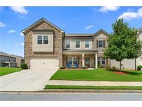 Charming two-story home with a brick and siding exterior, well-manicured lawn, and inviting curb appeal at 850 Ethereow Ct, Lawrenceville, GA 30046