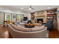 Inviting living room with stone fireplace, built-in bookshelves, and hardwood floors at 3912 Edenton Ne Ct, Brookhaven, GA 30319