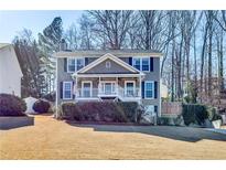 Charming two-story home with a covered front porch, a well-maintained lawn, and mature trees offering shade at 845 Connell Ln, Lawrenceville, GA 30044