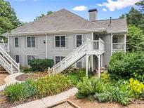 Charming gray two-story condo with white stairs and colorful landscaping at 111 Abingdon Way, Sandy Springs, GA 30328