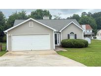 Charming single-story home featuring a two-car garage and manicured lawn at 2658 Deann Dr, Ellenwood, GA 30294