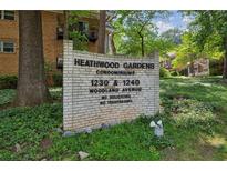 Sign for Heathwood Gardens Condominiums features vintage brick and landscaping at 1240 Woodland Ne Ave # 7, Atlanta, GA 30324