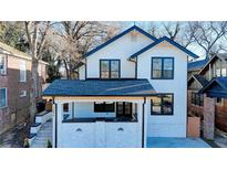 Beautifully renovated two-story home featuring a covered front porch and modern black-framed windows at 1456 S Gordon Sw St, Atlanta, GA 30310