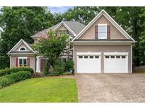 Charming two-story home with mature trees, a well-manicured lawn and two-car garage at 4016 Upland Trce, Marietta, GA 30066