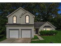 Charming two-story home with a two-car garage and beautifully landscaped front yard at 4464 Idlewood Park, Lithonia, GA 30038