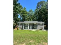 Charming two-story home with gray siding, white trim, shutters, and a well-maintained front yard at 1863 Rockford Ct, Riverdale, GA 30296