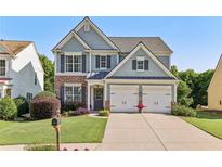 Charming two-story home with a well-manicured lawn and a two-car garage in a suburban neighborhood at 4020 Emerald Glade Ct, Cumming, GA 30040