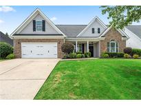 Charming brick home with a well-manicured lawn and inviting curb appeal on a sunny day at 21 Spring Folly Nw, Cartersville, GA 30121