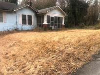 Exterior of light blue home with a covered front porch and large front yard at 702 Emily Pl # 0, Atlanta, GA 30318