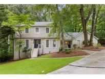 Charming two-story home with a well-manicured lawn and mature trees, offering great curb appeal at 2240 Six Branches Dr, Roswell, GA 30076