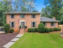 Charming two-story brick home with well-manicured lawn and inviting front entrance at 3131 Sumter Ct, Marietta, GA 30062