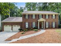 Charming two-story brick home with a well-manicured lawn and attached two-car garage at 4782 Donnegal Se Ct, Mableton, GA 30126