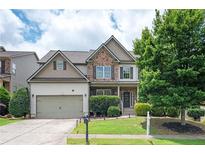 Beautiful two-story home featuring a two-car garage, stone accents, and well-maintained landscaping at 558 Olympic Way, Acworth, GA 30102