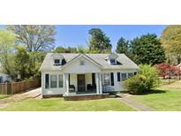 Charming home featuring a well-manicured lawn and a welcoming front porch perfect for relaxing outdoors at 8573 Campbellton St, Douglasville, GA 30134