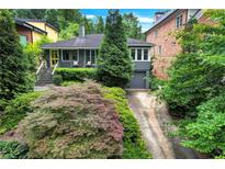 Charming home featuring a well-manicured front yard with beautiful landscaping at 935 Cumberland Ne Rd, Atlanta, GA 30306