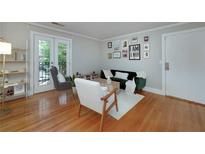 Inviting living room with french doors, modern furnishings and hardwood floors offers a cozy and bright space at 2023 Oakview Se Rd # 226, Atlanta, GA 30317