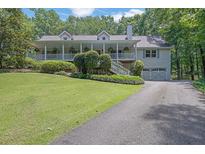 Charming home featuring a large front porch, dormer windows, and an attached two-car garage at 2095 Honeysuckle Dr, Cumming, GA 30040