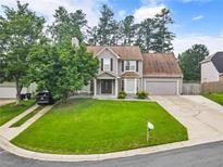 Charming two-story home with a well-manicured lawn, inviting curb appeal, and attached garage at 4903 Wilkie Nw Way, Acworth, GA 30102