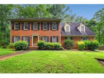 Charming brick two-story home with manicured lawn and traditional design details at 133 Sw Patterson Rd, Lawrenceville, GA 30044