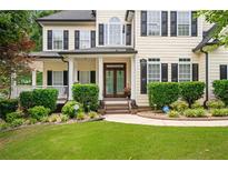 Charming home exterior boasts manicured lawn, lush landscaping, and inviting front porch at 5833 Wembley Dr, Douglasville, GA 30135