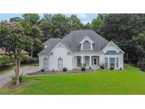 Charming, single-story home with a manicured lawn and white painted brick at 2330 Wood Creek Ct, Dacula, GA 30019
