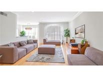 Bright living room features modern furnishings, hardwood floors, and plenty of natural light at 200 Renaissance Ne Pkwy # 219, Atlanta, GA 30308