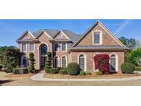 Traditional brick home with manicured landscaping and architectural details at 222 Chadmore Ln, Tyrone, GA 30290