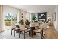 Open concept dining and living room with hardwood floors, neutral tones, and plenty of natural light at 8513 Polston Lot 137 Pl, Douglasville, GA 30134