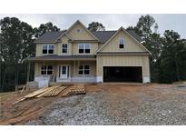 New two-story home featuring a covered porch, an attached two-car garage, and a neutral color palette at 1079 Birch Way Ct, Loganville, GA 30052
