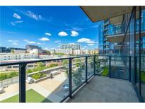 Expansive balcony area for condo featuring lounge furniture and unobstructed neighborhood views on a sunny day at 788 W Marietta Nw St # 212, Atlanta, GA 30318