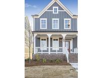 Charming two-story home with brick foundation, covered porch, and inviting curb appeal at 148 Palm St, Holly Springs, GA 30115