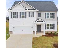 Charming two-story home with a two-car garage, gray shutters, and a well-manicured front yard at 1628 Palladian Dr, Lithonia, GA 30058