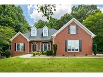 Charming one-story brick home featuring a beautifully landscaped front yard and traditional architectural details at 40 Costleys Bridge Dr, Oxford, GA 30054