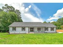Charming single-story home with a covered front porch, shutters, and lush front lawn at 858 Pates Creek Rd, Stockbridge, GA 30281