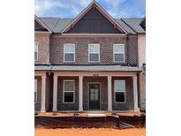 New construction townhouse with a brick facade and covered front porch at 3232 Cyrus Creek Dr, Kennesaw, GA 30152