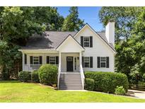 Charming two-story home featuring a welcoming front porch and well-maintained landscaping at 6280 Autry Mill Rd, Cumming, GA 30028