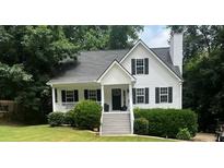 Charming white two-story home with a welcoming front porch and well-manicured landscaping at 6280 Autry Mill Rd, Cumming, GA 30028