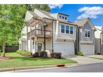 Charming two-story home featuring a covered balcony and attached two-car garage at 1858 Belmore Se St, Smyrna, GA 30080