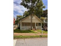 Traditional home featuring a covered front porch and well-maintained landscaping at 519 Roy Sw St, Atlanta, GA 30310
