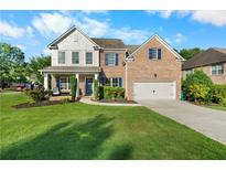 Charming two-story brick home featuring a manicured lawn, attached garage, and inviting front porch with stylish blue shutters at 109 Hale View Cir, Canton, GA 30114