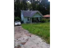 Charming bungalow-style home with a covered front porch and overgrown front yard at 3363 Lake Valley Nw Rd, Atlanta, GA 30331