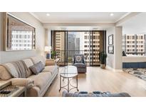 Bright living room featuring hardwood floors and a balcony with striking city views at 145 15Th Ne St # 1430, Atlanta, GA 30309