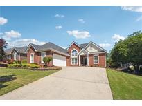 Beautiful brick home featuring a well-manicured lawn, white trim, a gray roof, and a spacious driveway at 5832 Sloane St, Douglasville, GA 30135