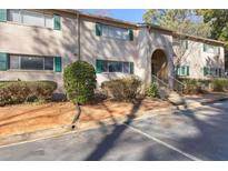 Brick exterior with green shutters and an arched entryway offers classic curb appeal at 3236 Henderson Mill Rd # 5, Atlanta, GA 30341