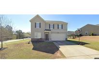 Charming two-story home with a well-maintained lawn and an attached two-car garage, perfect for Gathering living at 4505 Chandler Dr, Cumming, GA 30028