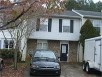 Two story home featuring a stone front, black door and black shutters on the front windows at 3541 Kennesaw Station Nw Dr, Kennesaw, GA 30144